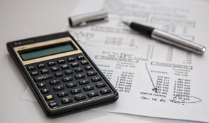 calculator and pen with financial document