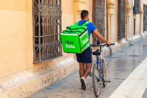 young-man- with-bicycle-delivering-UberEats